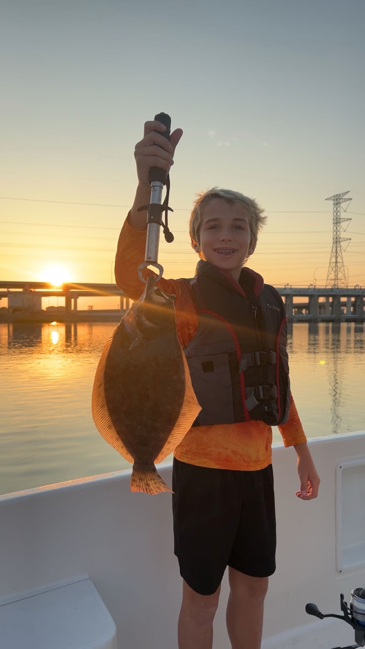 Boy holding a flounder