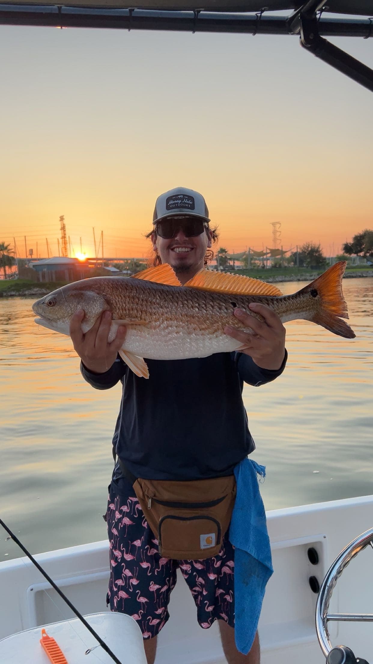 Man with redfish at sunset